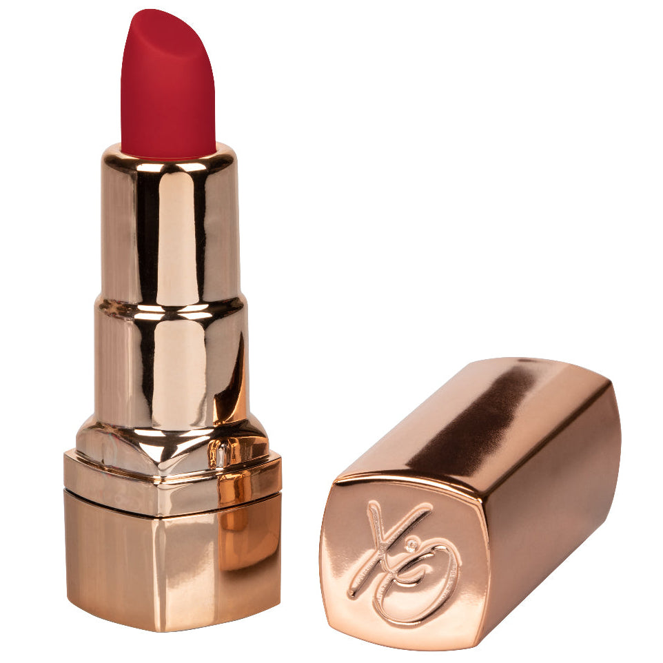 Red lipstick with rose gold case on a white background